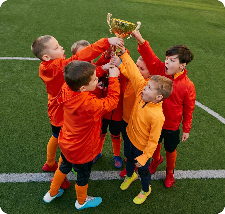 Childrens sports team holding trophy