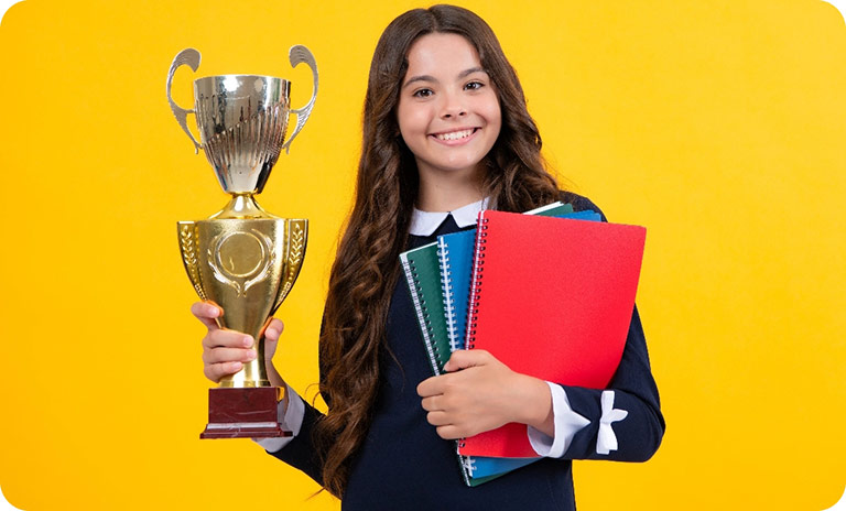 Young student holding award trophy