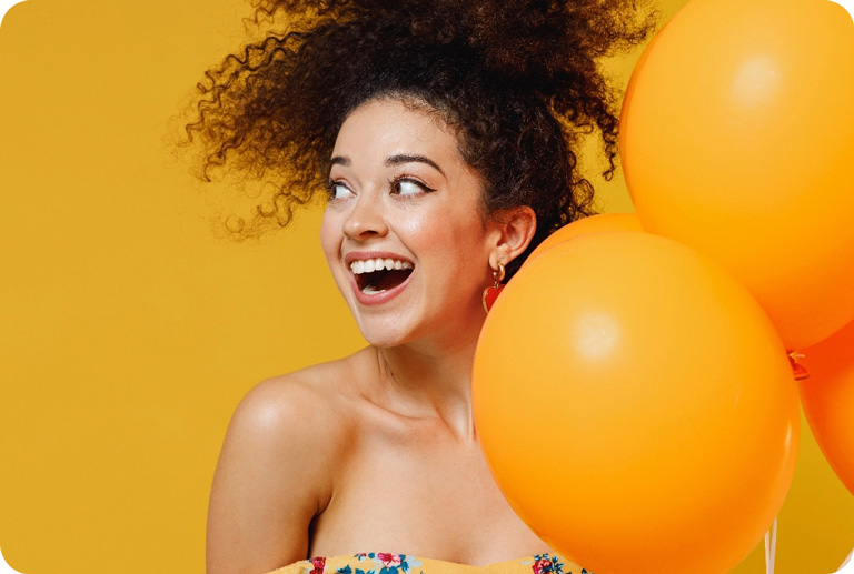 Woman holding orange balloons