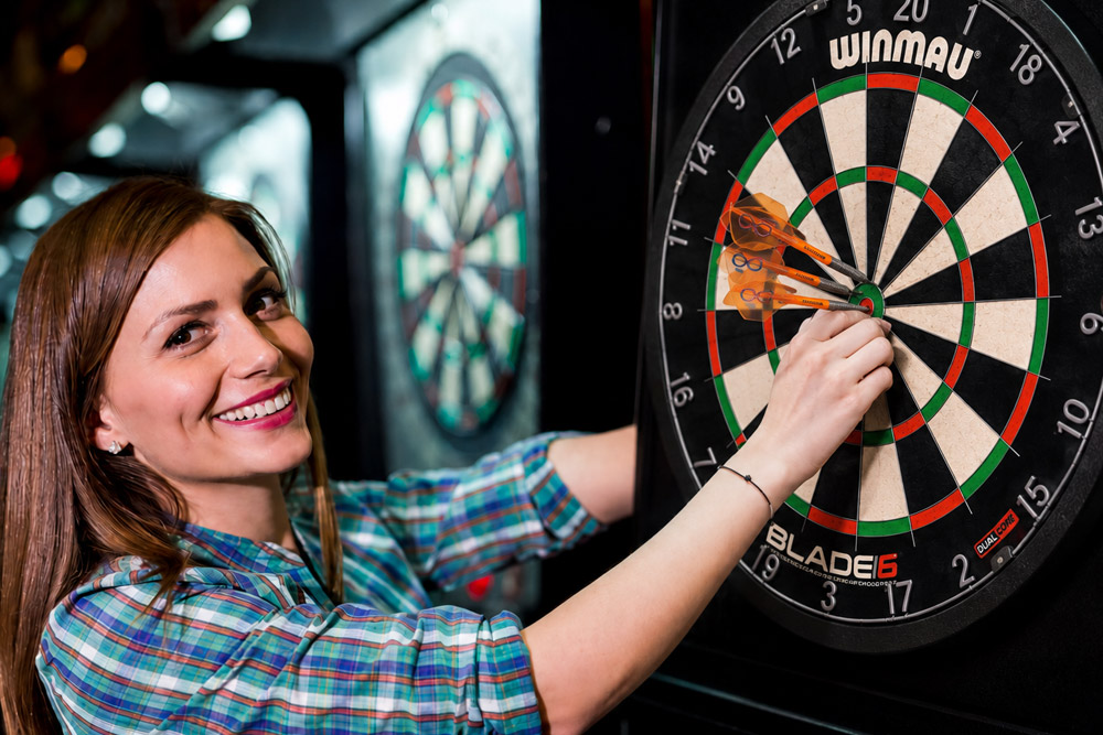 Woman playing darts winmau board
